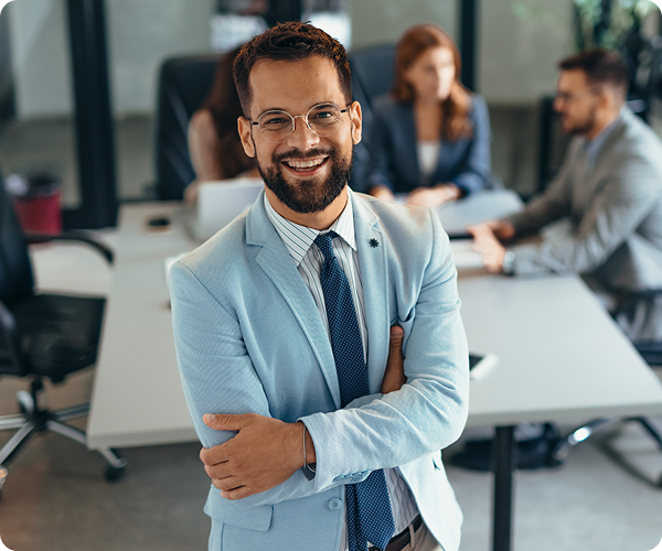 Smiling man in suit at office meeting.