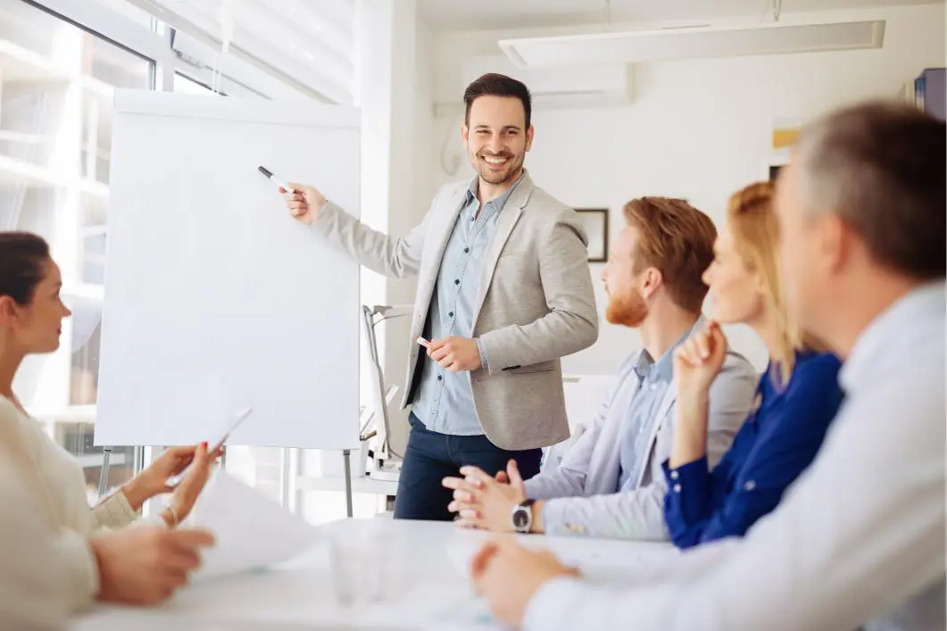 Man presenting to colleagues in a meeting.